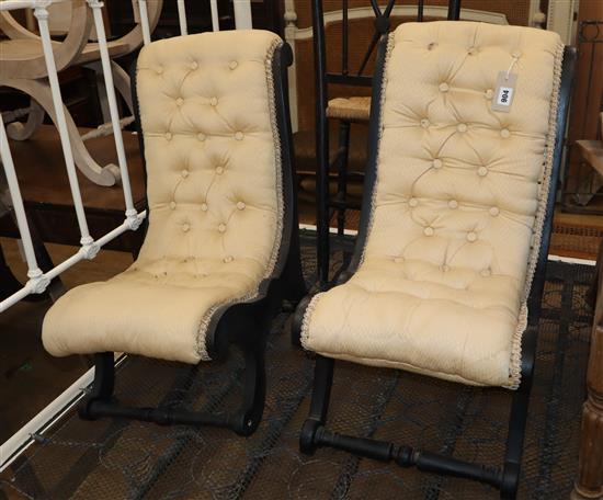 A pair of late Victorian ebonised slipper chairs